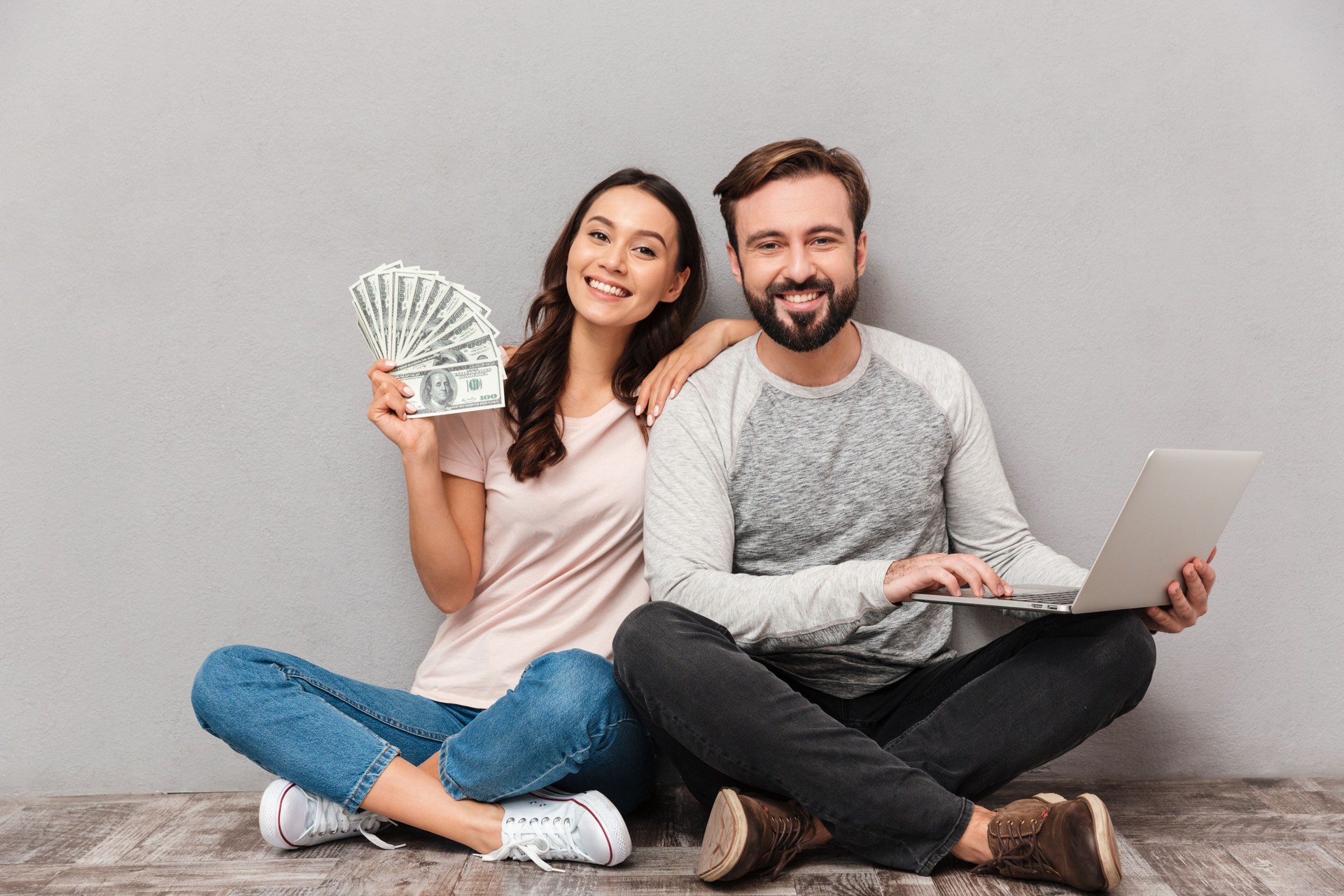 Portrait of a confident young couple with laptop computer